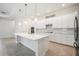 Bright kitchen featuring white cabinetry, stainless appliances, and a spacious island at 25143 Spartina Dr, Venice, FL 34293