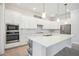 Modern kitchen with white cabinets, stainless appliances, and large center island at 25143 Spartina Dr, Venice, FL 34293