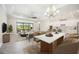 Open living space with eat in kitchen with pendant lighting and modern furnishings at 25143 Spartina Dr, Venice, FL 34293