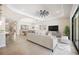 Spacious living room with modern furnishings, neutral color palette, and tile floors at 25143 Spartina Dr, Venice, FL 34293