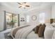 Bright main bedroom featuring a ceiling fan, tray ceiling, slider to outdoor patio and neutral decor at 25143 Spartina Dr, Venice, FL 34293
