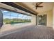 Screened-in pool patio with brick pavers, ceiling fan, beautiful view of the golf course, and access to the house via a sliding door at 25143 Spartina Dr, Venice, FL 34293