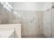 Walk-in tile shower featuring glass door and grab bar at 25143 Spartina Dr, Venice, FL 34293