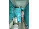 Bright blue bathroom featuring a white vanity and toilet at 27 Tucker Ave, Sarasota, FL 34232
