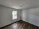 Bedroom features wood flooring, natural lighting, and neutral paint at 27 Tucker Ave, Sarasota, FL 34232