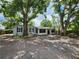 Charming single-story home with mature trees and a screened-in porch, offering a tranquil setting at 27 Tucker Ave, Sarasota, FL 34232