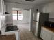 Bright kitchen featuring stainless steel refrigerator and stove at 27 Tucker Ave, Sarasota, FL 34232