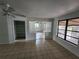Spacious living room, featuring tile flooring, standard ceiling fan, and access to additional living space at 27 Tucker Ave, Sarasota, FL 34232