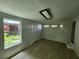 Bright room with light wood floors, white walls, and a view to the backyard at 27 Tucker Ave, Sarasota, FL 34232