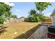 Large grassy backyard with wood fence and a small wood patio at 2802 21St W St, Bradenton, FL 34205