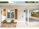 Close-up of the home's front entrance featuring a white door and decorative wood shutters at 2802 21St W St, Bradenton, FL 34205