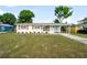 Charming home features a manicured front lawn and wood shutters at 2802 21St W St, Bradenton, FL 34205