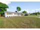 Charming single-story home with wood shutters, a carport, and a manicured lawn at 2802 21St W St, Bradenton, FL 34205