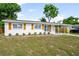 Charming single-story home with tidy landscaping, white exterior, and wood-style shutters at 2802 21St W St, Bradenton, FL 34205