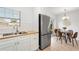 Efficient kitchen layout with stainless steel appliances and a dining area view with backyard access at 2802 21St W St, Bradenton, FL 34205