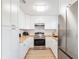 Well-lit kitchen with stainless steel appliances and wooden countertops, complemented by white cabinetry at 2802 21St W St, Bradenton, FL 34205