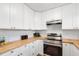 Bright kitchen with butcher block counters, white cabinets, and stainless steel appliances at 2802 21St W St, Bradenton, FL 34205