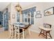 Cozy dining area with modern lighting, shutters, and decor with pool view at 2875 Grazeland Dr, Sarasota, FL 34240