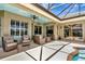 Outdoor patio with tiled ceiling, wicker seating, and sliding glass doors at 2875 Grazeland Dr, Sarasota, FL 34240
