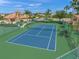 Aerial view of a well-maintained tennis court with green and blue surfacing and surrounding fence at 2875 Grazeland Dr, Sarasota, FL 34240