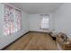 Empty bedroom with hardwood floors and colorful curtains that provides natural lighting at 305 Chauncey Ave, Bradenton, FL 34208