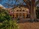 City of Bradenton building under large tree, surrounded by lush landscaping and leaf-covered ground at 305 Chauncey Ave, Bradenton, FL 34208