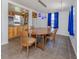 Bright dining area featuring modern lighting, wooden table and chairs, complemented by vivid blue curtains at 305 Chauncey Ave, Bradenton, FL 34208