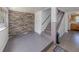 Inviting entryway featuring a stone accent wall, staircase, and durable flooring, blending style and function at 305 Chauncey Ave, Bradenton, FL 34208
