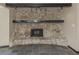 Inviting living room features a stone fireplace, wood mantle, and slate flooring at 305 Chauncey Ave, Bradenton, FL 34208