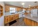 Cozy eat-in kitchen features ample countertop space, natural wood cabinets and stainless-steel sink at 305 Chauncey Ave, Bradenton, FL 34208