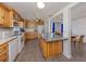 Spacious eat-in kitchen boasts wood cabinetry, an island with countertop, and lots of natural light at 305 Chauncey Ave, Bradenton, FL 34208