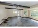 Spacious living room with tile flooring, exposed beams, and large windows with natural light at 305 Chauncey Ave, Bradenton, FL 34208