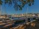 Picturesque marina view from the pier with benches, boats docked, and clear blue skies at 305 Chauncey Ave, Bradenton, FL 34208
