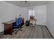 Bright office area featuring a wooden desk, blue office chair, and a printer with neutral patterned carpet at 305 Chauncey Ave, Bradenton, FL 34208