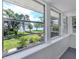 Enclosed patio area with views of the lush landscaped yard and waterfront at 305 Chauncey Ave, Bradenton, FL 34208