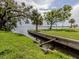 Waterfront property featuring serene canal, mature trees, and landscaped grassy area, a picturesque setting at 305 Chauncey Ave, Bradenton, FL 34208