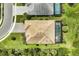 Drone-eye image of a property showcasing the tile roof, private backyard, screened lanai with a pool, and a paver driveway at 3379 Chestertown Loop, Bradenton, FL 34211