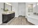 Luxurious bathroom featuring granite countertops, soaking tub and a separate glass enclosed shower at 3379 Chestertown Loop, Bradenton, FL 34211