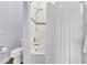 Bathroom with bathtub and shower featuring a white shower curtain and tiled walls at 3379 Chestertown Loop, Bradenton, FL 34211