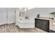 Elegant bathroom featuring a soaking tub, granite countertops, and dark wood cabinets at 3379 Chestertown Loop, Bradenton, FL 34211