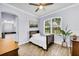 Cozy bedroom with natural light, wood floors, and en-suite bathroom at 3379 Chestertown Loop, Bradenton, FL 34211