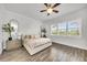 Bright bedroom offers wood-look tile flooring and a large window with plantation shutters at 3379 Chestertown Loop, Bradenton, FL 34211