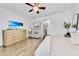 Inviting primary bedroom with wood-look floors, soft lighting, and comfortable seating area at 3379 Chestertown Loop, Bradenton, FL 34211