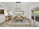 Well-lit dining room with modern light fixture, sideboard, and outdoor views at 3379 Chestertown Loop, Bradenton, FL 34211