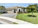 Lovely home with a paver driveway, three-car garage, tile roof, manicured lawn, and inviting curb appeal at 3379 Chestertown Loop, Bradenton, FL 34211