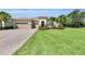 Beautiful residence with a paver driveway, three-car garage, tile roof, vibrant landscaping, and inviting front entrance at 3379 Chestertown Loop, Bradenton, FL 34211