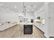 Modern kitchen with a center island, white cabinets, and stainless steel appliances at 3379 Chestertown Loop, Bradenton, FL 34211