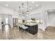 Spacious kitchen with stainless steel appliances, granite countertops, and a large center island at 3379 Chestertown Loop, Bradenton, FL 34211