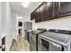 Convenient laundry room features modern washer and dryer, sink, and ample cabinets for storage at 3379 Chestertown Loop, Bradenton, FL 34211