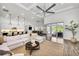 Bright living area with hardwood floors, neutral decor, open floor plan, and modern ceiling fan at 3379 Chestertown Loop, Bradenton, FL 34211